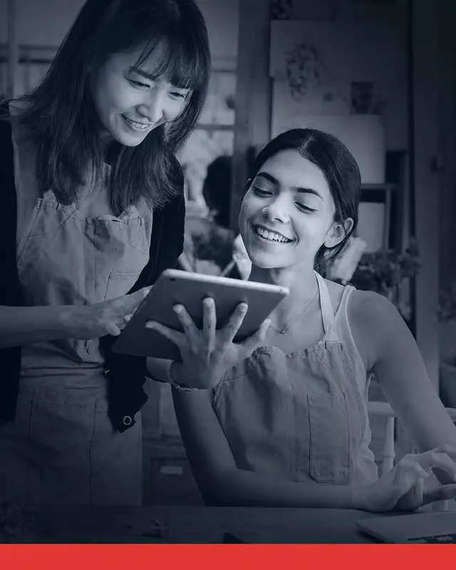 Two business owners reviewing their digital marketing results together on a tablet