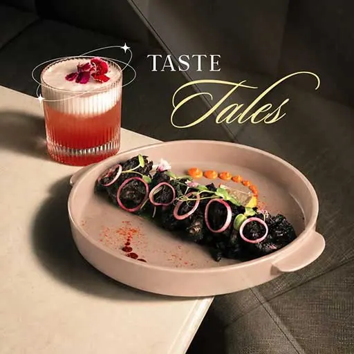 Taste Tales restaurant post: a plated dish beside a pink cocktail